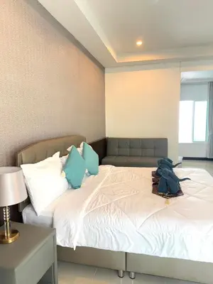 a bedroom with a bed with a backpack on it at Green Haven Villas in Krabi town