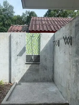a door in a concrete wall with a window at Green Haven Villas in Krabi town