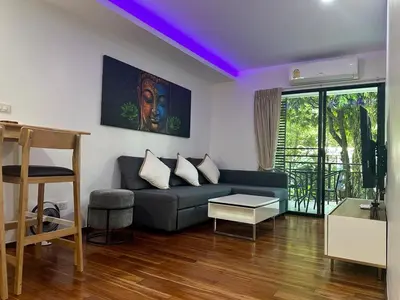 a living room with a couch and a purple ceiling at Apartment Title III Rawai Phuket in Rawai Beach