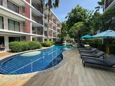 a swimming pool in front of a building at Apartment Title III Rawai Phuket in Rawai Beach