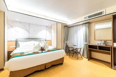 a hotel room with a bed and a desk at Phuket Patong Buri Resort in Patong Beach