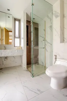 a bathroom with a glass shower and a toilet at WEG Laguna Residence in Thalang