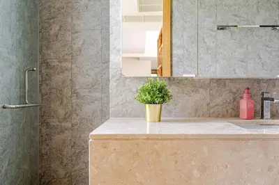 a bathroom with a sink and a plant on a counter at WEG Laguna Residence in Thalang