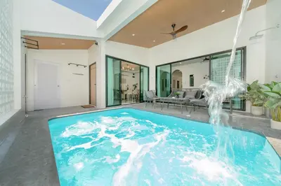 an indoor swimming pool with a water fountain in a house at 6BR Patong pool villa in Patong Beach