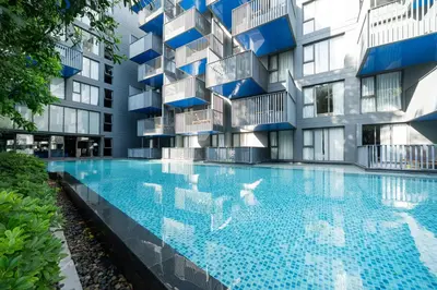 an apartment building with a large swimming pool at Patong luxurious Vacation one bedroom Apt The deck in Patong Beach