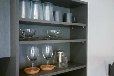 a shelf with wine glasses and a pitcher on it at Patong luxurious Vacation one bedroom Apt The deck in Patong Beach