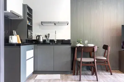 a kitchen with two chairs and a table in it at Patong luxurious Vacation one bedroom Apt The deck in Patong Beach