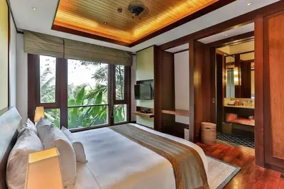 a bedroom with a large bed with a large window at Villa Daran Luxury Villa with Panoramic Views & 5-Star Services in Kamala Beach