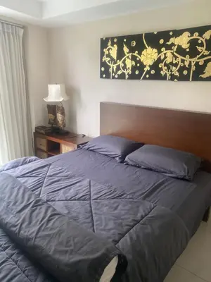 a bedroom with a large bed with blue sheets at Cristians lägenhet in Kata Beach
