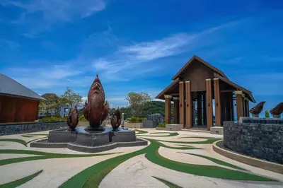 a building with a statue in the middle of a courtyard at Surin Mida Grande residence with jacuzzi and sea view - Bang Tao & Surin beach in Surin Beach