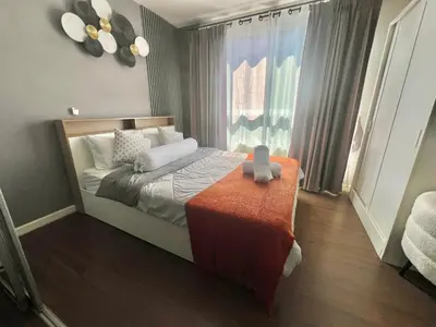 a small bedroom with a bed and a window at Dcreek 79 Modern chic condo near patong in Phuket Town