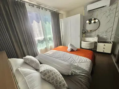 a bedroom with a bed and a mirror and a window at Dcreek 79 Modern chic condo near patong in Phuket Town