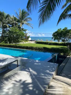 a swimming pool with a view of the ocean at Beachfront in Surin Beach