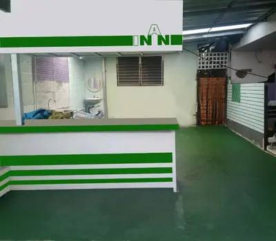 an empty garage with a green floor and a counter at Nan Inn Bungalow in Karon Beach