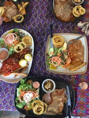 a group of plates of food on a table at Nan Inn Bungalow in Karon Beach