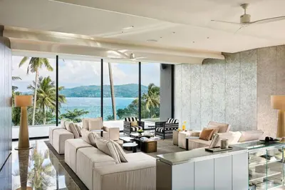 a living room with white furniture and a view of the ocean at Villa Zai in Kata Beach