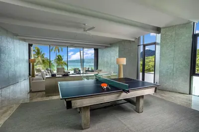a pool table in a living room with a view of the ocean at Villa Zai in Kata Beach