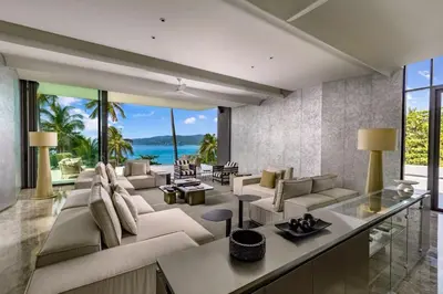 a living room with white furniture and a view of the ocean at Villa Zai in Kata Beach