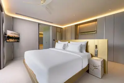 a large white bed in a hotel room at Villa Zai in Kata Beach