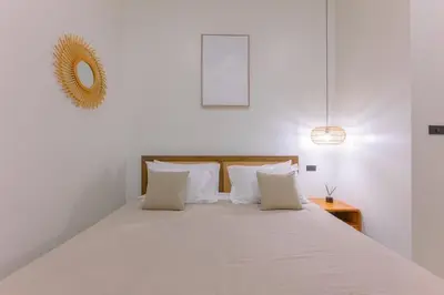 a white bedroom with a large bed with white pillows at Balina Private Pool Villa in Ban Chin Tham Mai