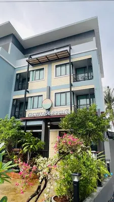a building with flowers in front of it at The Village Poshtel in Ban Khlong Haeng
