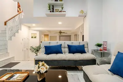 a living room with a couch and blue pillows at 2 bed townhouse, best location, Patong in Patong Beach