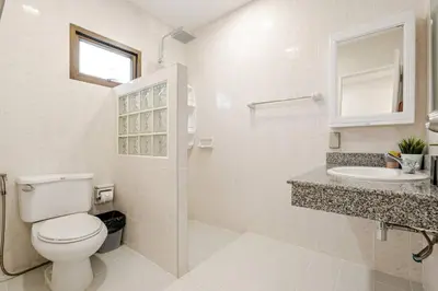 a white bathroom with a toilet and a sink at 2 bed townhouse, best location, Patong in Patong Beach