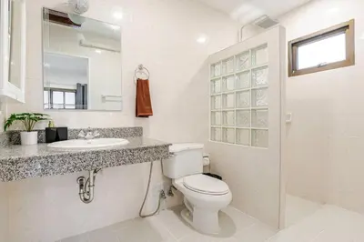 a white bathroom with a toilet and a sink at 2 bed townhouse, best location, Patong in Patong Beach