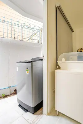 a small refrigerator in a room with a window at 2 bed townhouse, best location, Patong in Patong Beach