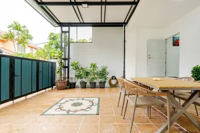 a patio with a table and chairs and plants at 2 bed townhouse, best location, Patong in Patong Beach