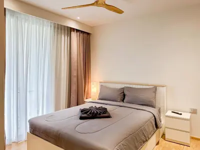a bedroom with a large bed and a window at Laguna BeachSide Apartment in Bang Tao Beach