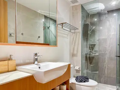a bathroom with a sink and a shower and a toilet at Laguna BeachSide Apartment in Bang Tao Beach