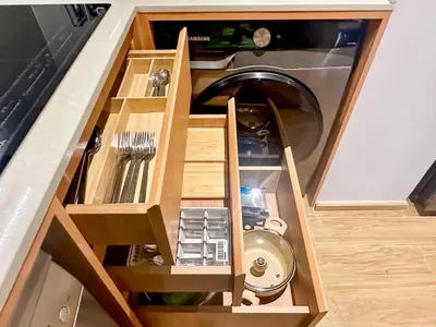 a kitchen with a washing machine in a cabinet at Laguna BeachSide Apartment in Bang Tao Beach
