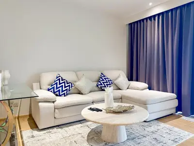 a living room with a couch and a table at Laguna BeachSide Apartment in Bang Tao Beach