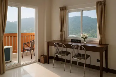 a room with a table and two chairs and a window at Payton House Patong - Newly Renovated in Patong Beach