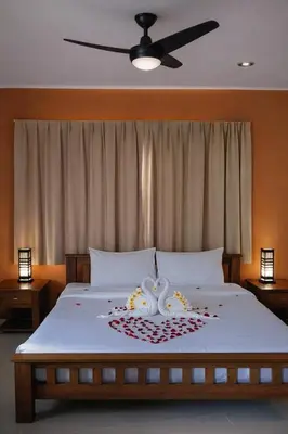 a bedroom with a bed with a flower arrangement on it at Payton House Patong - Newly Renovated in Patong Beach