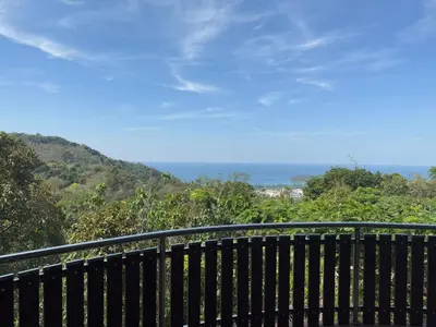 a balcony with a view of the ocean at Choncharm house 2 in Kata Beach