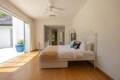 a bedroom with a bed and a ceiling fan at Top Pool Villa Layan Estate Laguna Bangtao in Layan Beach
