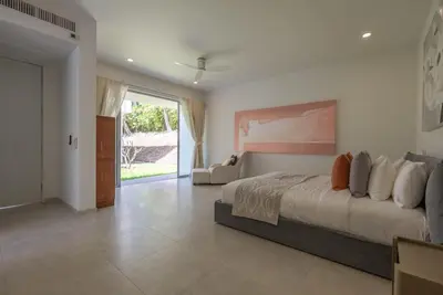 a bedroom with a large bed and a living room at Top Pool Villa Layan Estate Laguna Bangtao in Layan Beach