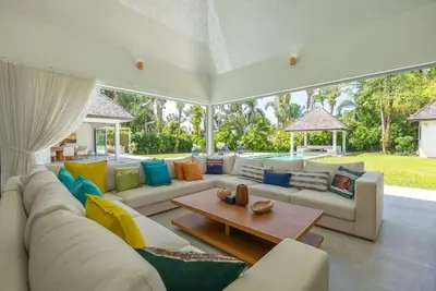 a large living room with a couch and a table at Top Pool Villa Layan Estate Laguna Bangtao in Layan Beach