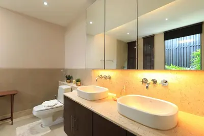a bathroom with two sinks and a toilet at Coconut villa Phuket in Laguna Phuket
