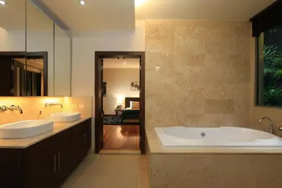 a large bathroom with two sinks and a tub at Coconut villa Phuket in Laguna Phuket