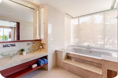 a bathroom with a tub and a large window at Luxuriously private seafront Bangtao beach in Surin Beach