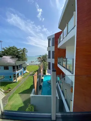 a view from the balcony of a house with a swimming pool at Luxuriously private seafront Bangtao beach in Surin Beach