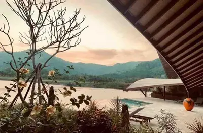 a view of the mountains from the patio of a house at Tranquil lake view villa on Phuket golf estate in Kathu