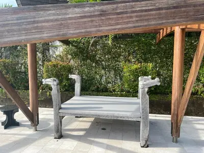 a white bench sitting under a wooden gazebo at Tranquil lake view villa on Phuket golf estate in Kathu