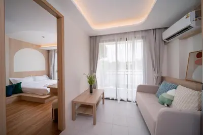 a living room with a couch and a bed at \u5168\u65b0\u73b0\u4ee3\u98ce\u683c \u9b45\u529b\u6cf3\u6c60\u516c\u5bd3 in Kamala Beach