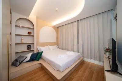 a small bedroom with a bed and a television at \u5168\u65b0\u73b0\u4ee3\u98ce\u683c \u9b45\u529b\u6cf3\u6c60\u516c\u5bd3 in Kamala Beach