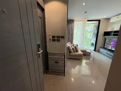 a door leading to a living room with a couch at Citygate Kamala beach, luxury apartment, Phuket in Kamala Beach