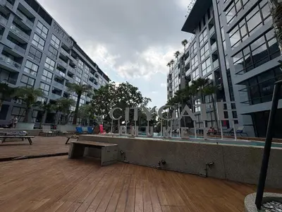 a bench in the middle of a city with buildings at Citygate Kamala beach, luxury apartment, Phuket in Kamala Beach